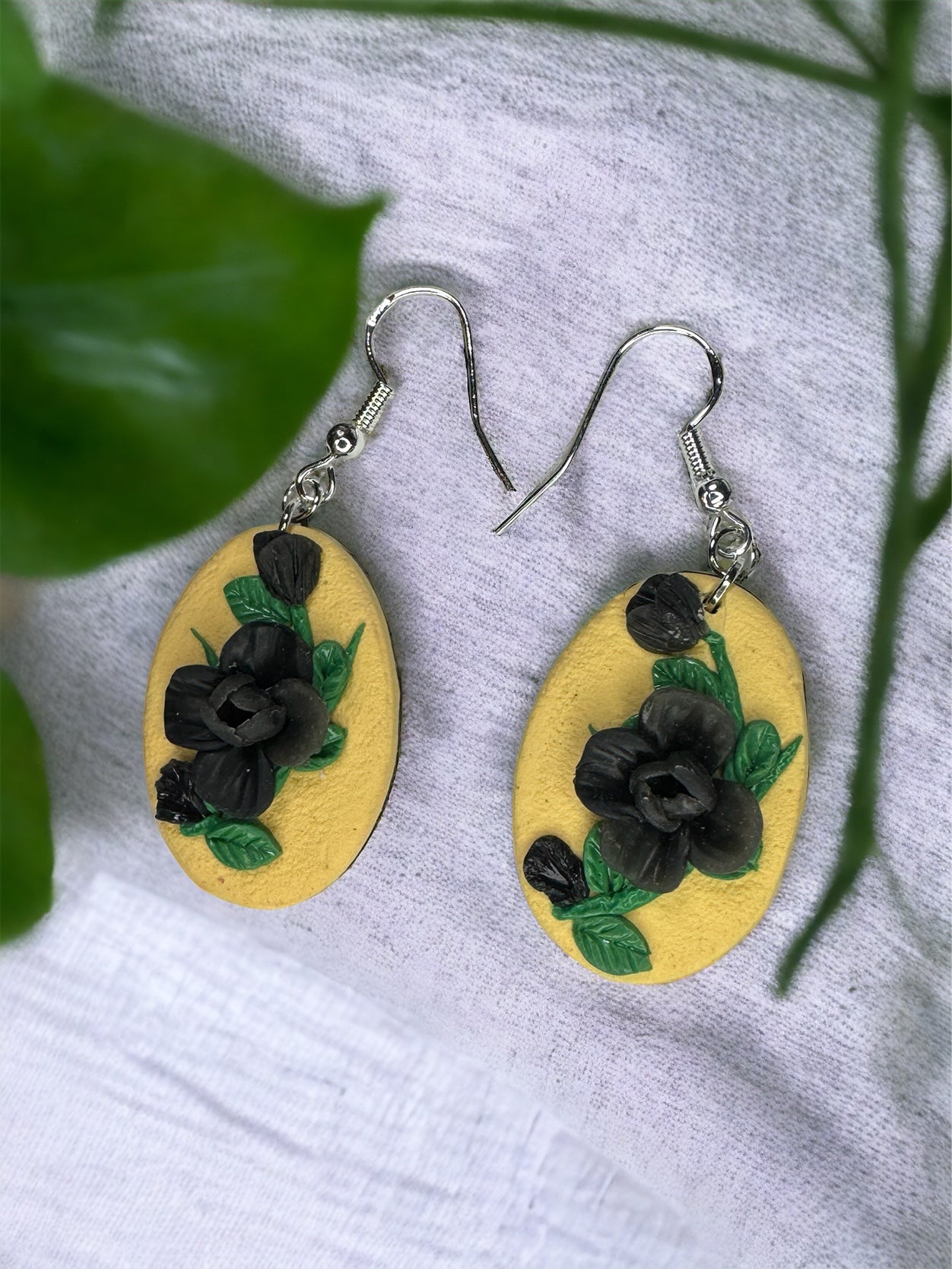 Pale yellow and black floral earrings